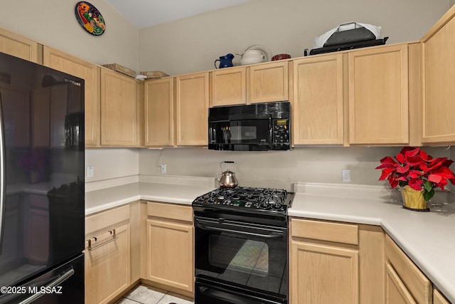 kitchen with black appliances and light brown cabinets