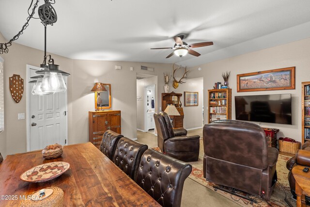 dining room with carpet flooring, a ceiling fan, and visible vents