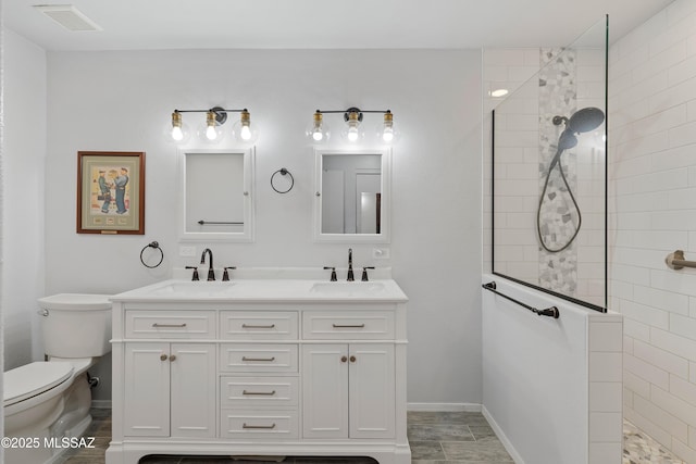 bathroom with visible vents, toilet, walk in shower, and a sink