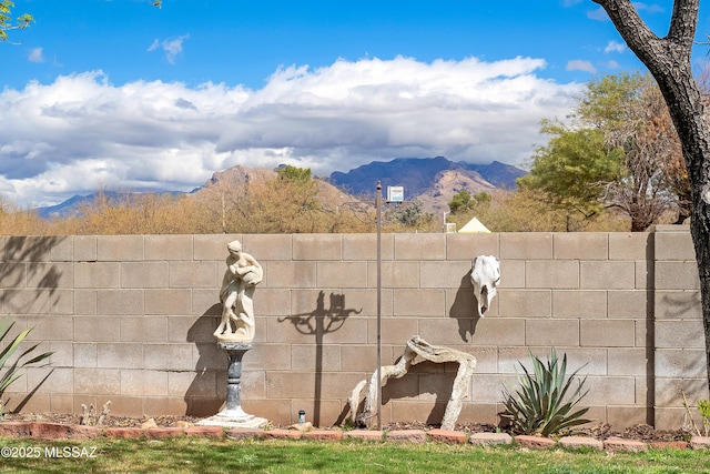 exterior space with a mountain view and fence