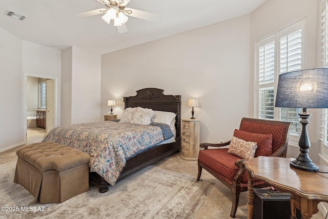 bedroom featuring connected bathroom, baseboards, visible vents, and ceiling fan