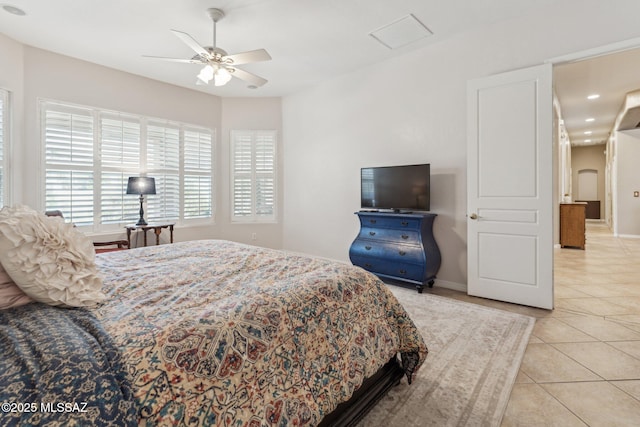 bedroom with light tile patterned floors, baseboards, and ceiling fan