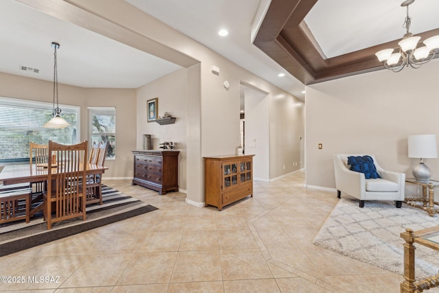 dining space with light tile patterned floors, visible vents, baseboards, and an inviting chandelier