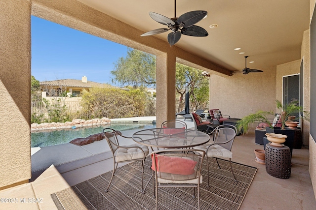 view of patio with outdoor dining area, a fenced in pool, ceiling fan, and fence