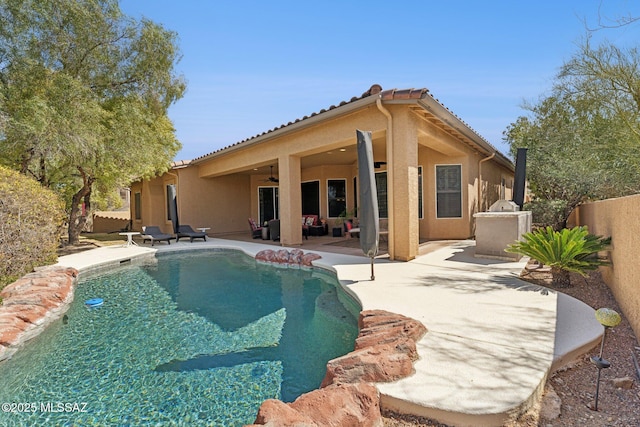 view of swimming pool featuring a patio area, a fenced backyard, a fenced in pool, and ceiling fan