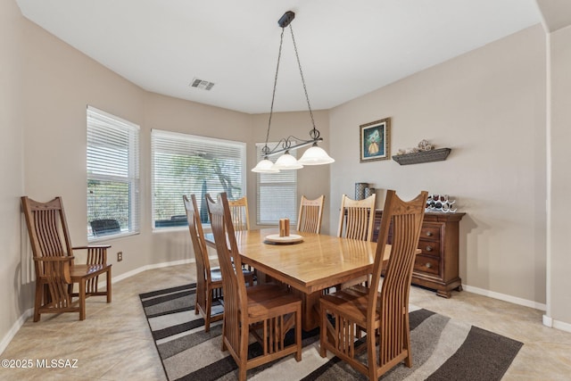 dining room featuring light tile patterned floors, visible vents, and baseboards