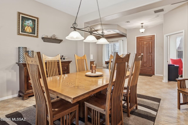 dining area featuring light tile patterned floors, visible vents, and baseboards