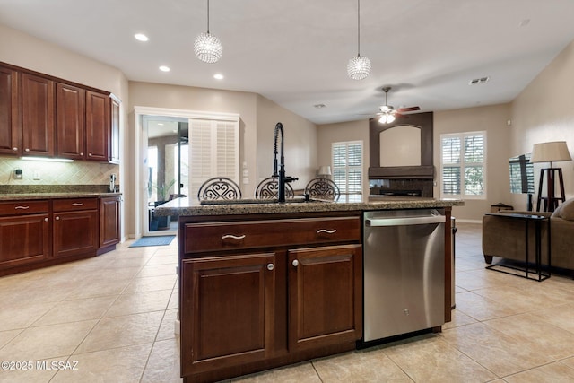 kitchen featuring backsplash, ceiling fan, open floor plan, dishwasher, and hanging light fixtures