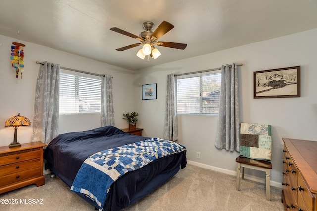 bedroom with baseboards, light colored carpet, and a ceiling fan