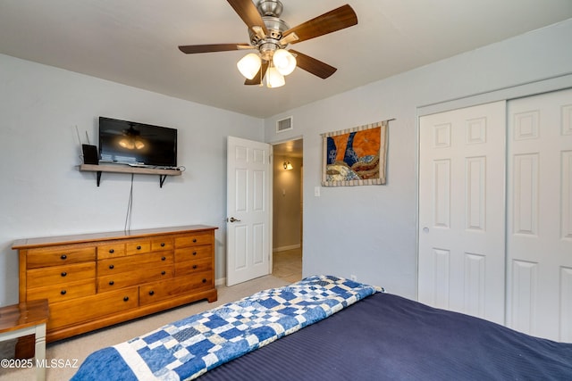 bedroom with visible vents, light carpet, a ceiling fan, a closet, and baseboards