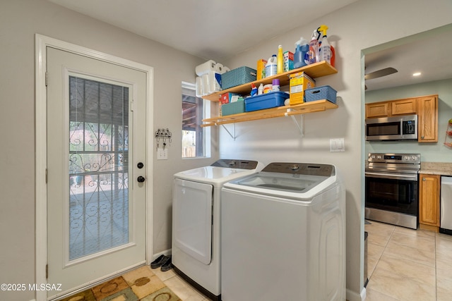 laundry area with washer and clothes dryer, laundry area, and light tile patterned flooring