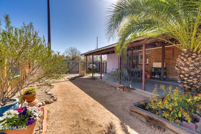 view of yard featuring a gate, a patio, and fence