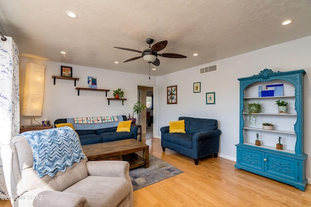 living area featuring visible vents, light wood-style flooring, recessed lighting, baseboards, and ceiling fan