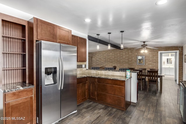 kitchen with dark wood finished floors, a peninsula, stainless steel fridge with ice dispenser, and pendant lighting