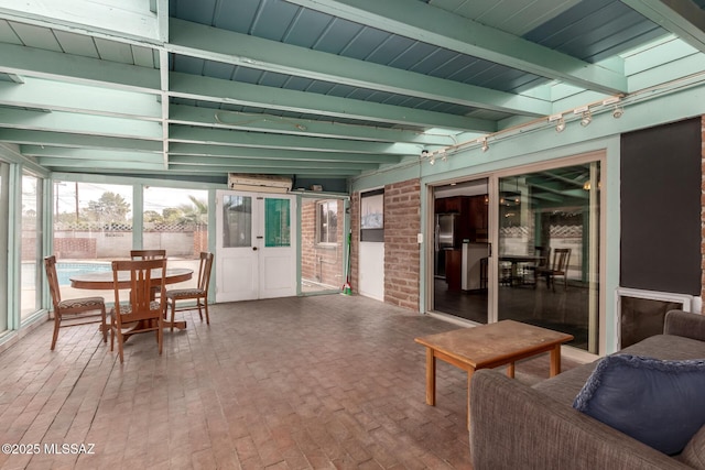 sunroom with beam ceiling