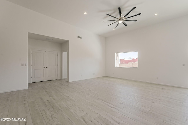 spare room with visible vents, baseboards, a ceiling fan, and light wood finished floors