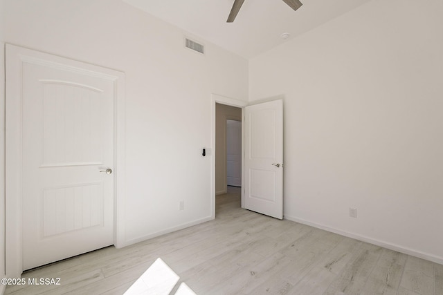 unfurnished bedroom featuring visible vents, baseboards, and wood finished floors