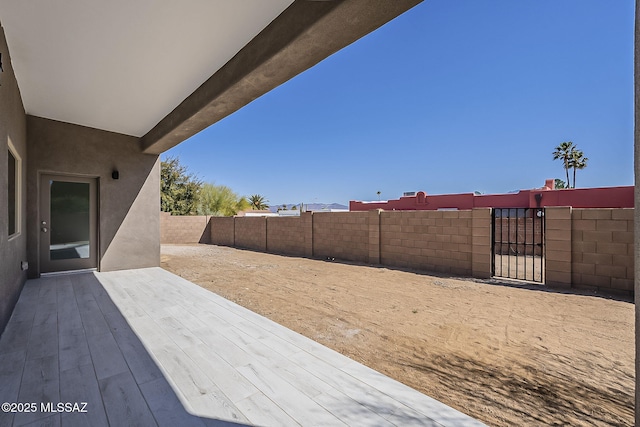 view of patio / terrace featuring a fenced backyard and a gate