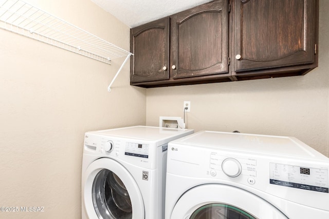 laundry area with cabinet space and independent washer and dryer