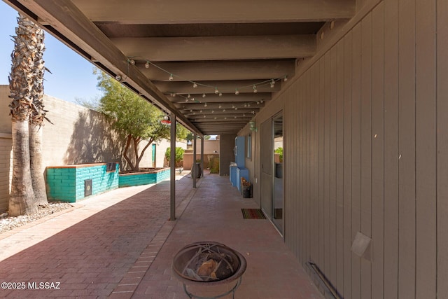 view of patio featuring a fenced in pool, a fire pit, and a fenced backyard