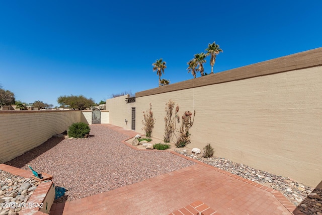 view of yard featuring a patio area and a fenced backyard