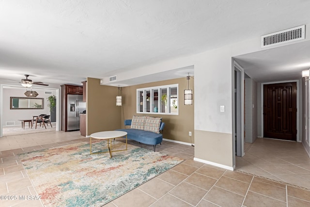 living room with light tile patterned flooring and visible vents