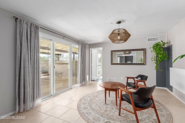 living area with light tile patterned floors, baseboards, and visible vents