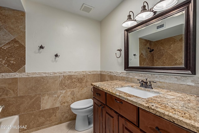 full bathroom featuring tile patterned floors, visible vents, toilet, and tile walls