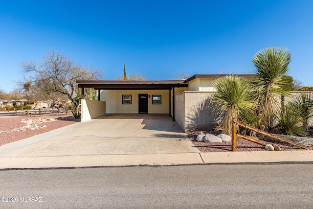 view of front of property with an attached carport and driveway