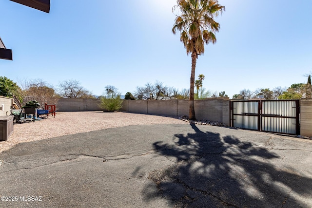 view of yard featuring a gate and fence private yard