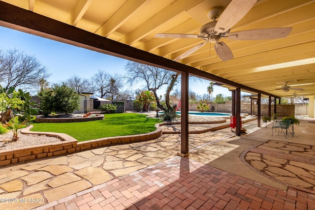 view of patio featuring a ceiling fan, a fenced backyard, and a fenced in pool