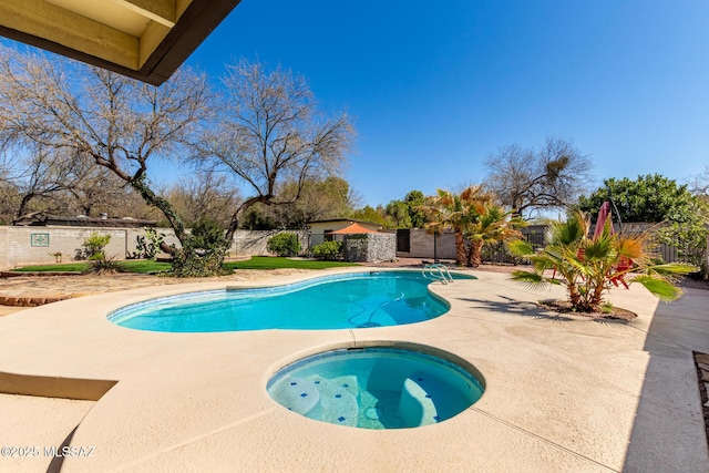 view of swimming pool featuring a patio, a fenced in pool, a fenced backyard, and an in ground hot tub