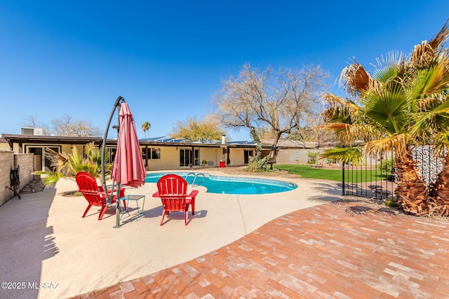 view of swimming pool with a fenced in pool, fence, and a patio area