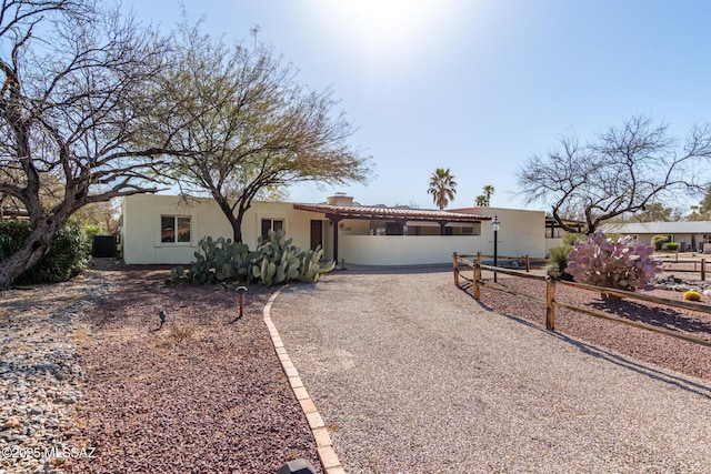 single story home featuring stucco siding, cooling unit, a tile roof, and driveway