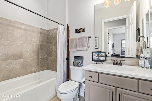 bathroom with backsplash, toilet, vanity, and shower / bath combo with shower curtain