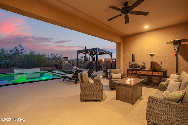 view of patio / terrace with an outdoor pool, an outdoor living space with a fire pit, and ceiling fan