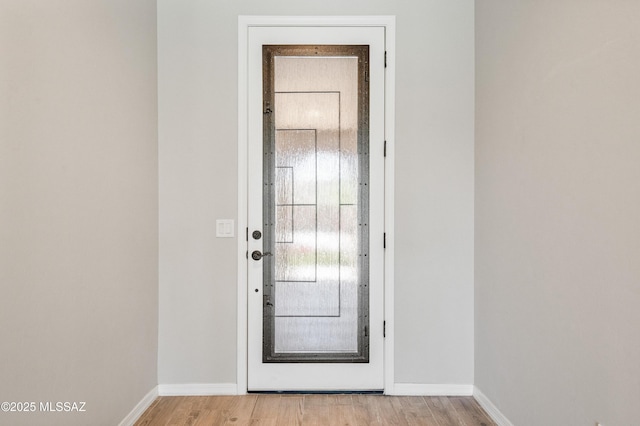 6909 W Cliff Spring Trl, Marana, AZ 85658 - doorway with baseboards and light wood-style floors