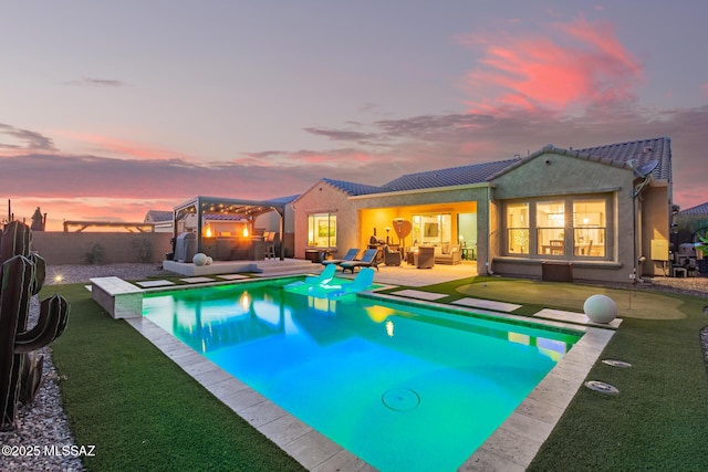 pool at dusk with a fenced in pool, outdoor lounge area, a fenced backyard, a pergola, and a patio