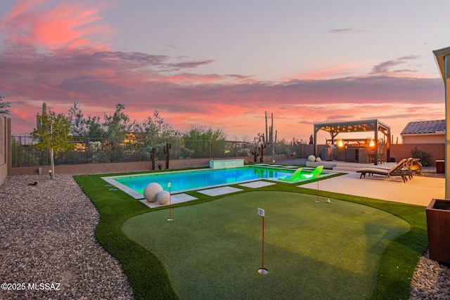 pool at dusk featuring a patio, a jacuzzi, a fenced backyard, and a fenced in pool