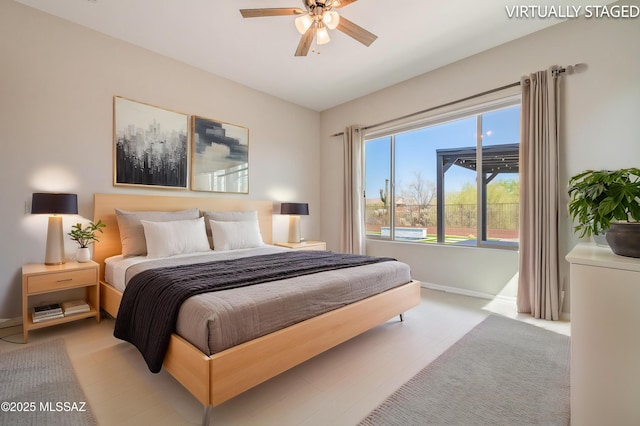 6909 W Cliff Spring Trl, Marana, AZ 85658 - bedroom with baseboards and ceiling fan