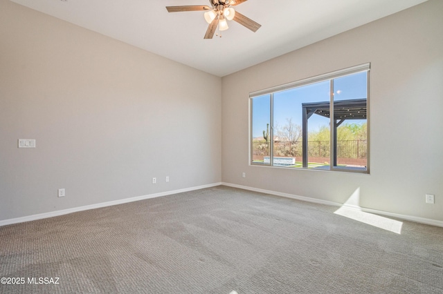 6909 W Cliff Spring Trl, Marana, AZ 85658 - spare room featuring carpet floors, ceiling fan, and baseboards