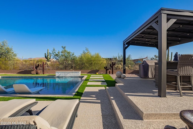 view of pool with a patio, fence, a fenced in pool, and grilling area