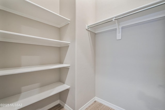 6909 W Cliff Spring Trl, Marana, AZ 85658 - spacious closet featuring wood finished floors