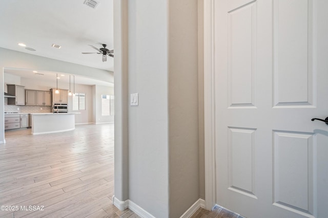 6909 W Cliff Spring Trl, Marana, AZ 85658 - hallway featuring baseboards, light wood-style floors, and recessed lighting