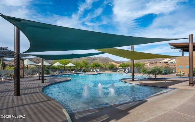 community pool featuring a patio area and fence