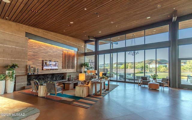 6909 W Cliff Spring Trl, Marana, AZ 85658 - community lobby with a high ceiling, a wall of windows, and wood ceiling