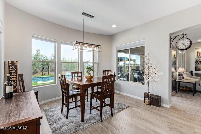 dining area with recessed lighting, light wood-type flooring, and baseboards