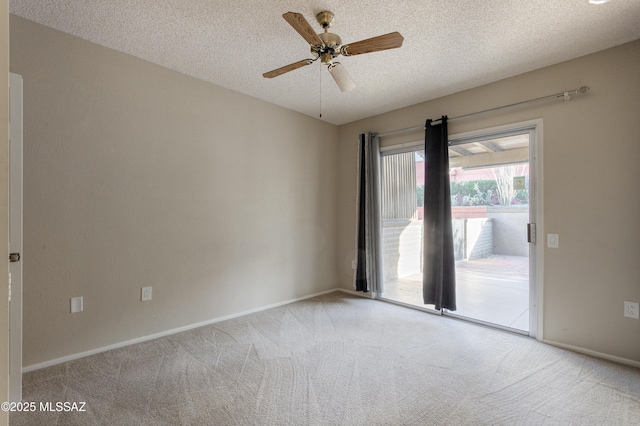 carpeted empty room with baseboards, a textured ceiling, and a ceiling fan