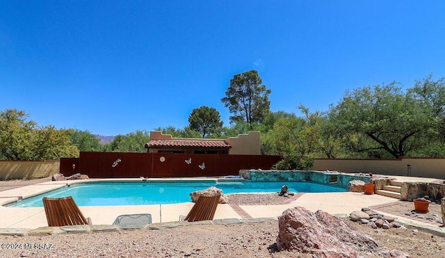 view of pool with fence and a fenced in pool