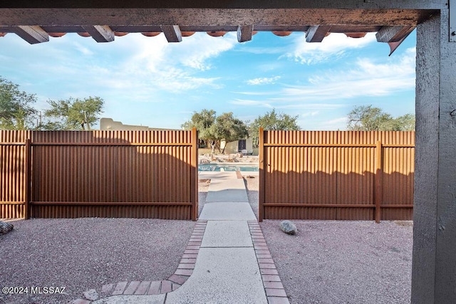 view of gate featuring a fenced in pool and fence